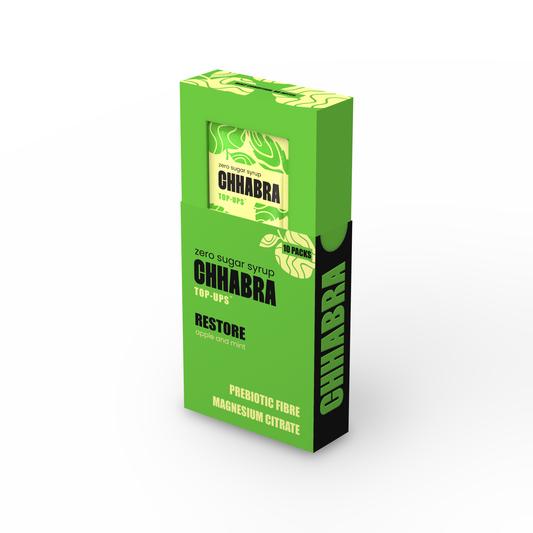 A green and black box of chhabra Restore prebiotic fibre magnesium citrate, shown at a three-quarter angle on a white background.