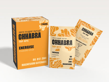 Chabra Top-Ups Energise masala chai zero sugar syrup packaging, showing a large orange and black box alongside two individual sachets on a clean white background.